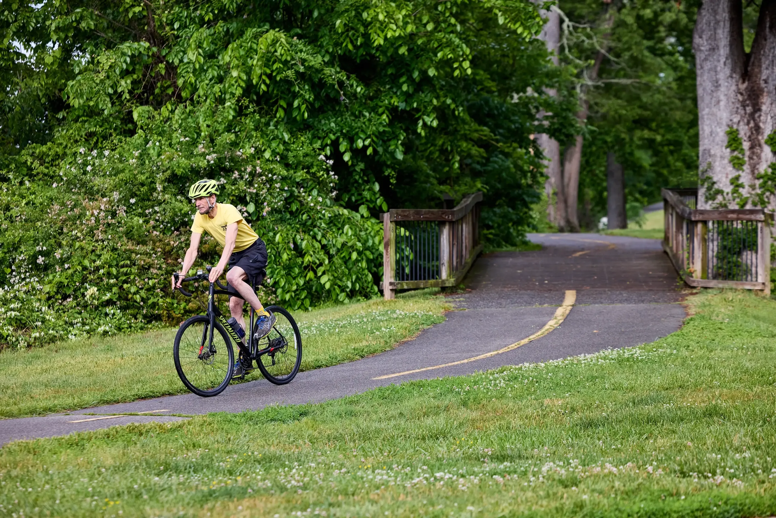 A man on a bike exiting a trail