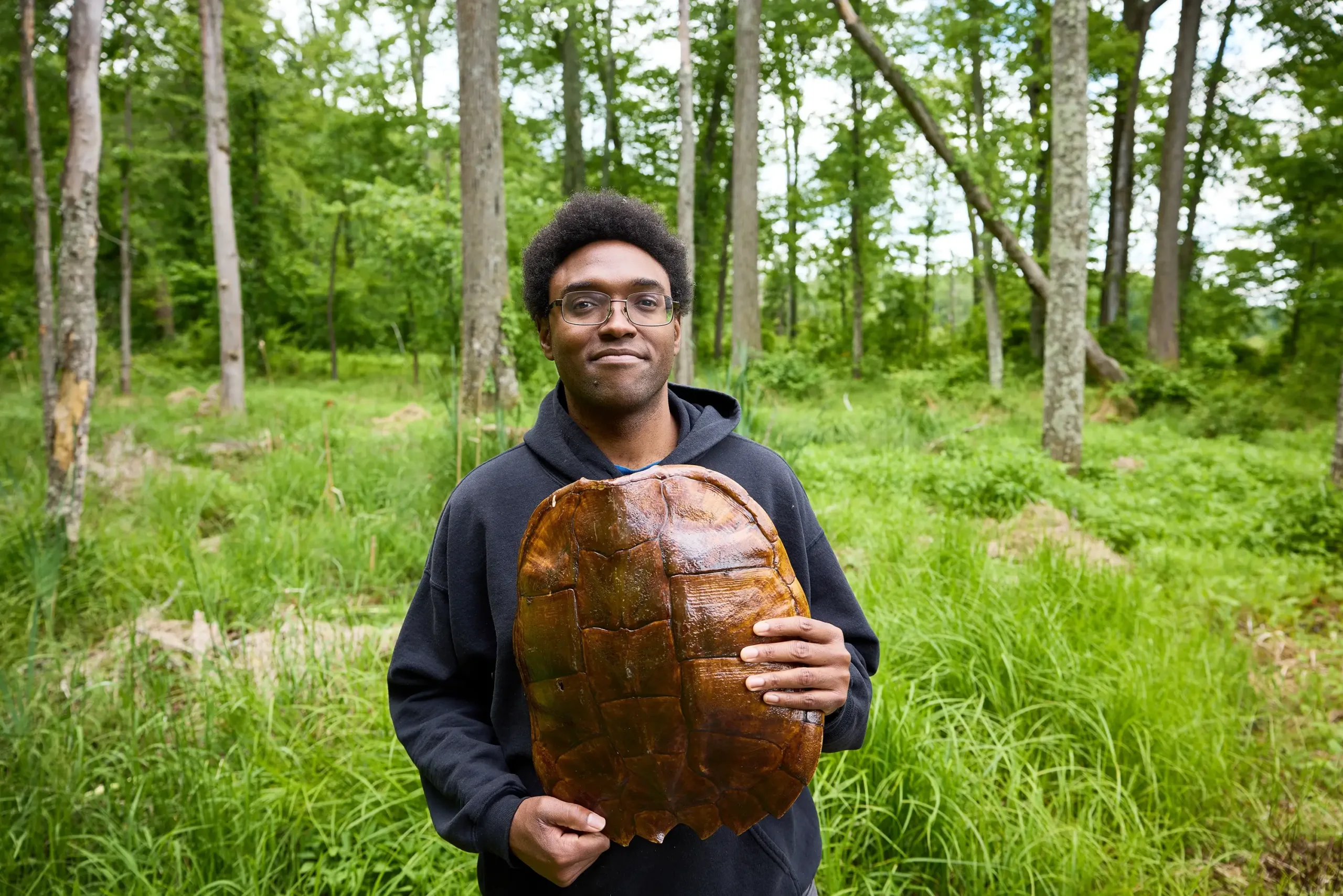 A man holding a turtle shell